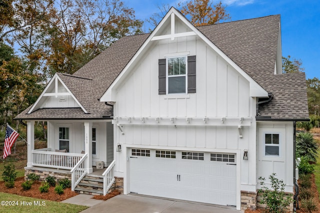 modern farmhouse style home featuring covered porch and a garage