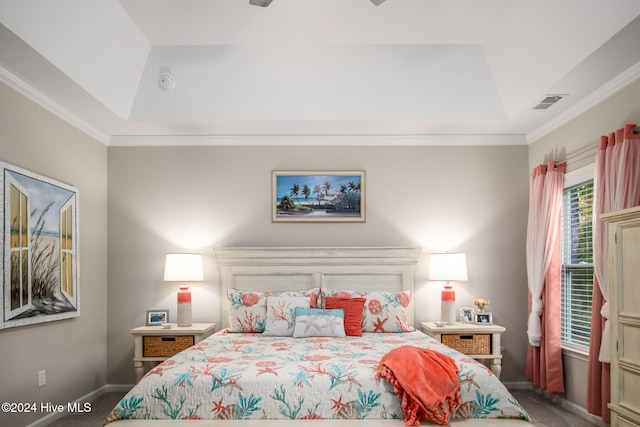 carpeted bedroom featuring a tray ceiling and crown molding