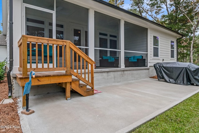 view of patio with grilling area and a sunroom