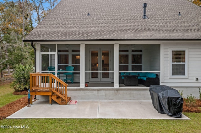 rear view of house featuring a sunroom, an outdoor living space, and a patio