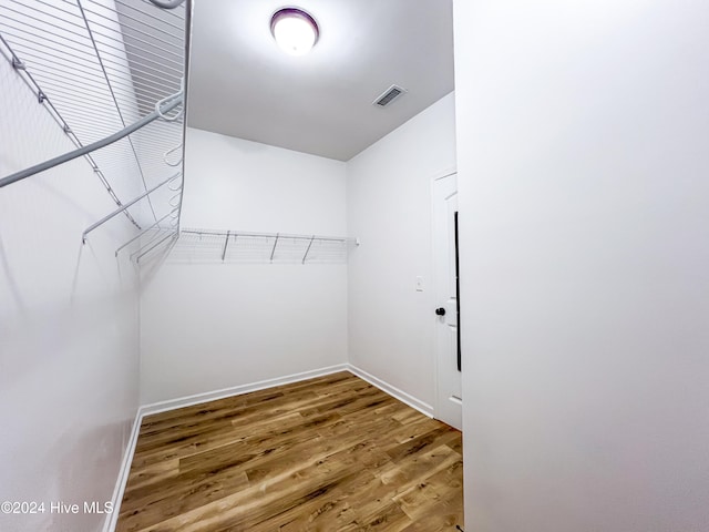 spacious closet featuring hardwood / wood-style floors