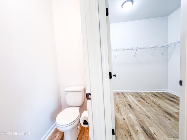 bathroom featuring hardwood / wood-style flooring and toilet