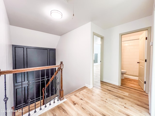 interior space featuring light hardwood / wood-style floors and lofted ceiling