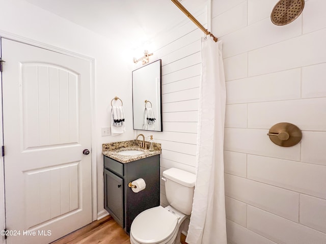 bathroom featuring hardwood / wood-style flooring, vanity, toilet, and a shower with shower curtain