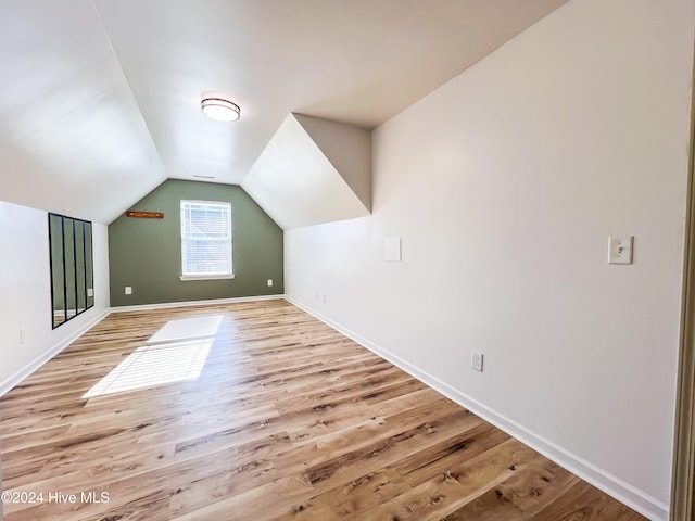 bonus room featuring light hardwood / wood-style floors and vaulted ceiling