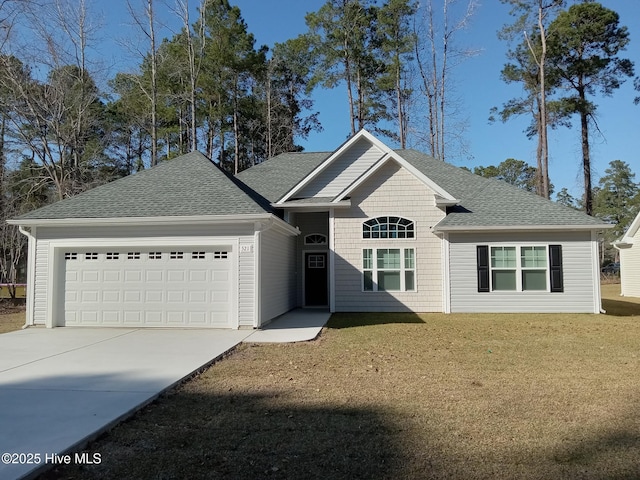 view of front of home featuring an attached garage, driveway, a front yard, and roof with shingles