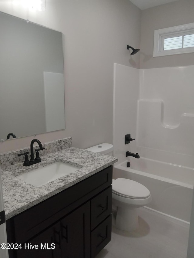 bathroom featuring vanity, shower / bathing tub combination, and toilet