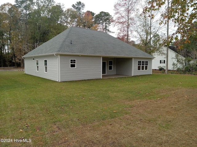 back of property with a lawn