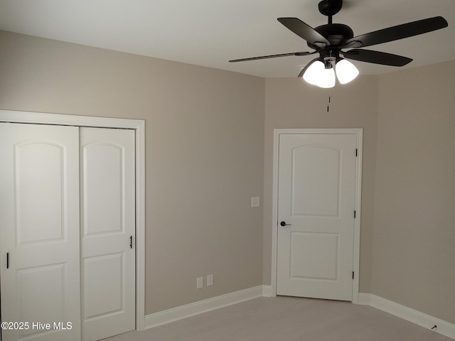 unfurnished bedroom featuring a closet, baseboards, and ceiling fan