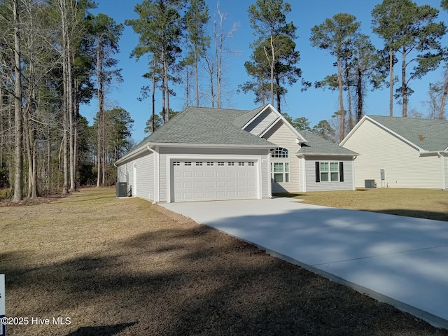 view of front of property with a front lawn, an attached garage, central AC unit, and driveway