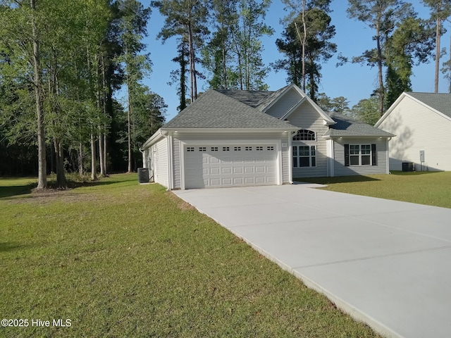 view of front of house with central AC unit, a front lawn, a garage, and concrete driveway