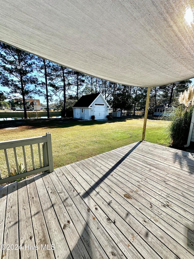 deck with a yard and an outdoor structure