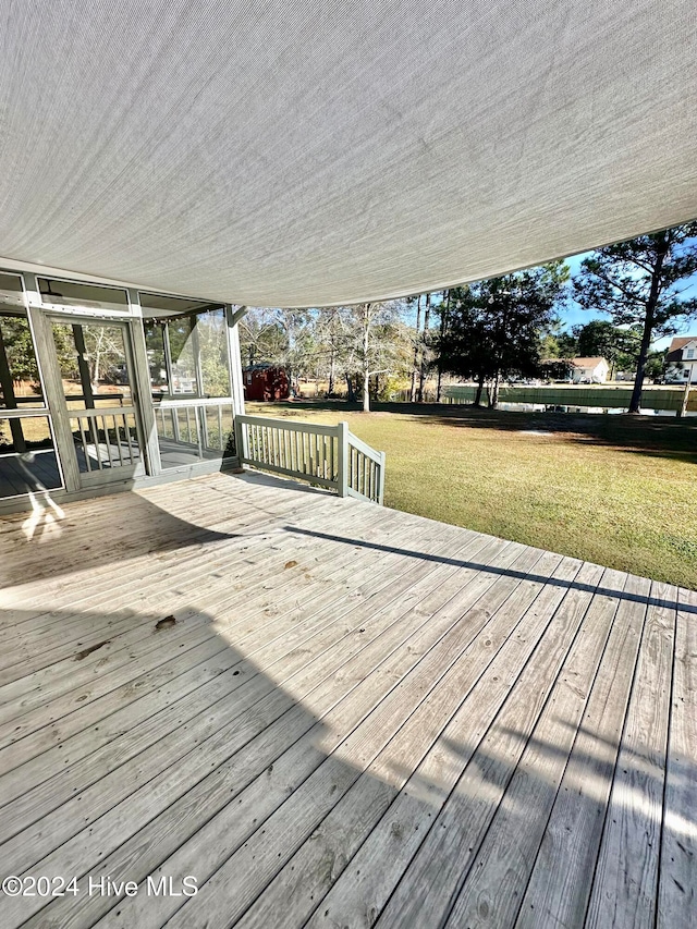 deck featuring a lawn and a sunroom