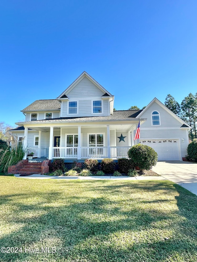 view of front facade featuring a porch, a garage, and a front yard