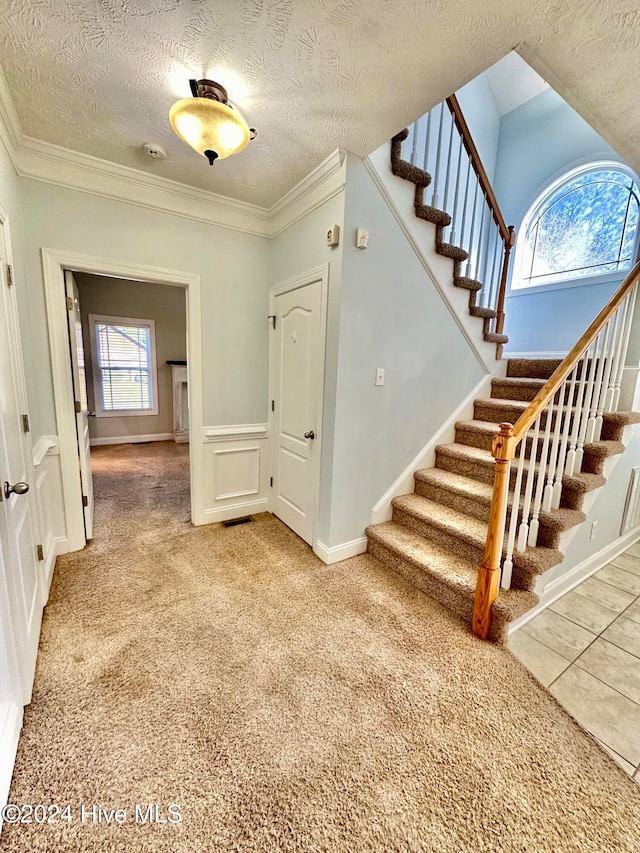 stairway with carpet flooring and a healthy amount of sunlight