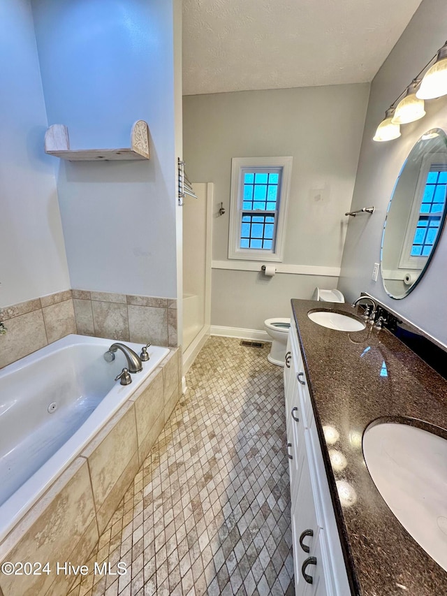 full bathroom featuring vanity, tile patterned flooring, separate shower and tub, toilet, and a textured ceiling