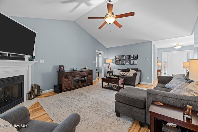 living room featuring light hardwood / wood-style flooring, ceiling fan, and lofted ceiling