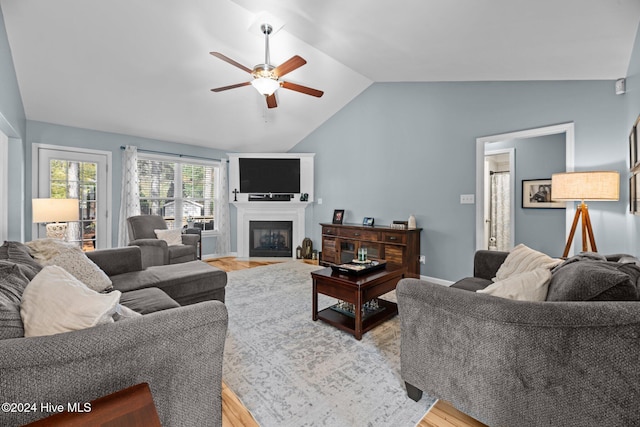 living room featuring hardwood / wood-style floors, vaulted ceiling, and ceiling fan