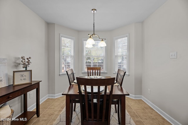 dining room with a chandelier, light tile patterned floors, and a healthy amount of sunlight