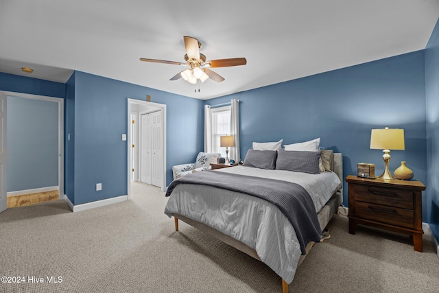 bedroom with ceiling fan, carpet floors, and a closet