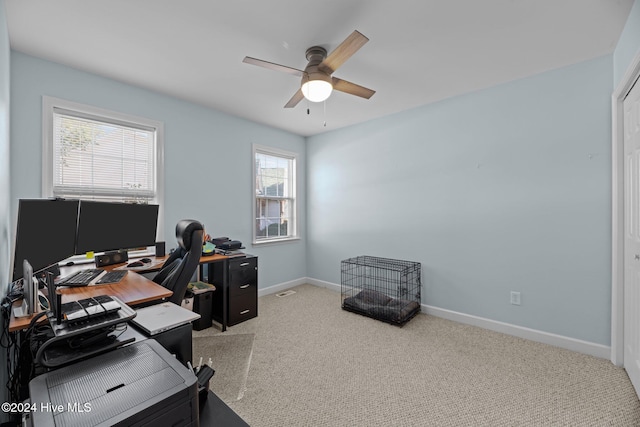 carpeted office space with ceiling fan