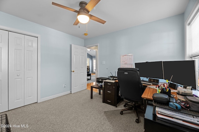 carpeted office featuring ceiling fan