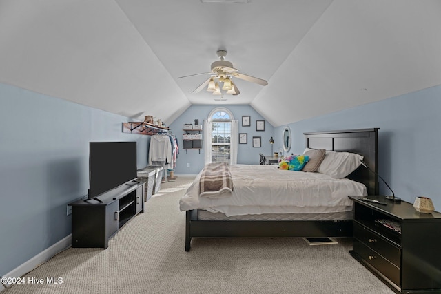 carpeted bedroom featuring vaulted ceiling and ceiling fan