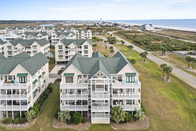 bird's eye view featuring a water view and a beach view