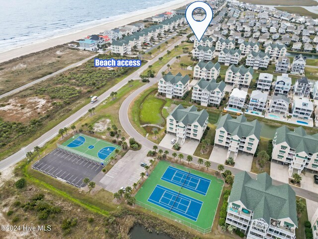 birds eye view of property featuring a water view and a view of the beach