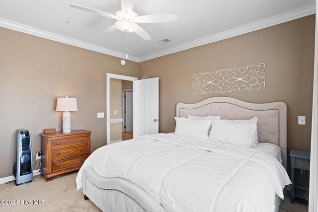 carpeted bedroom with ceiling fan and crown molding