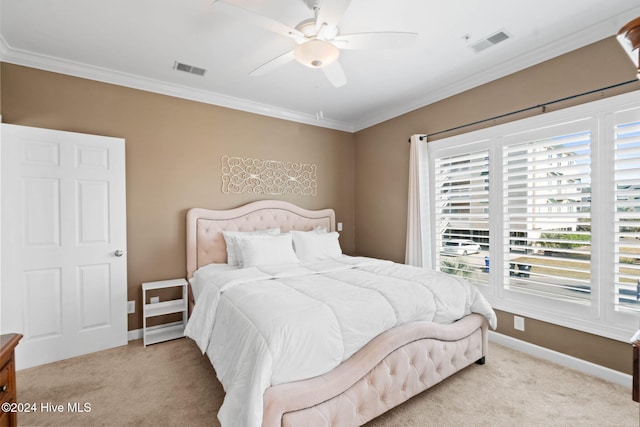 carpeted bedroom with ceiling fan and crown molding