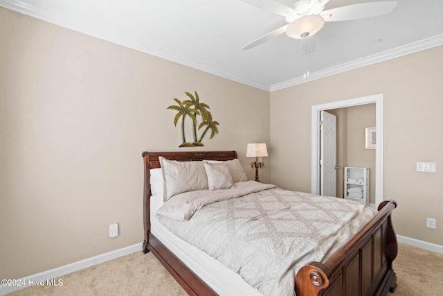 carpeted bedroom featuring ceiling fan and crown molding