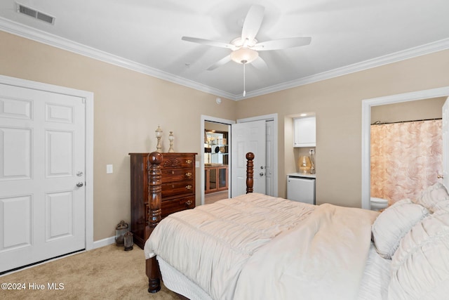 carpeted bedroom with connected bathroom, ceiling fan, and crown molding