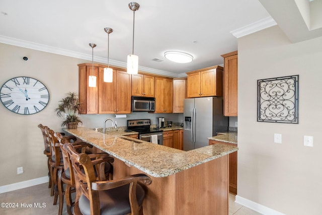 kitchen featuring kitchen peninsula, light stone countertops, ornamental molding, stainless steel appliances, and decorative light fixtures