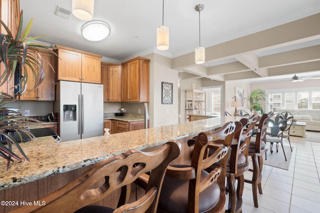 kitchen with stainless steel refrigerator with ice dispenser, ceiling fan, light stone countertops, decorative light fixtures, and kitchen peninsula