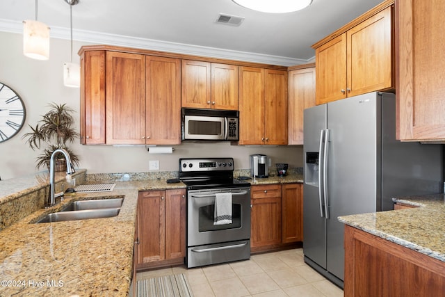 kitchen featuring light stone countertops, sink, hanging light fixtures, stainless steel appliances, and ornamental molding