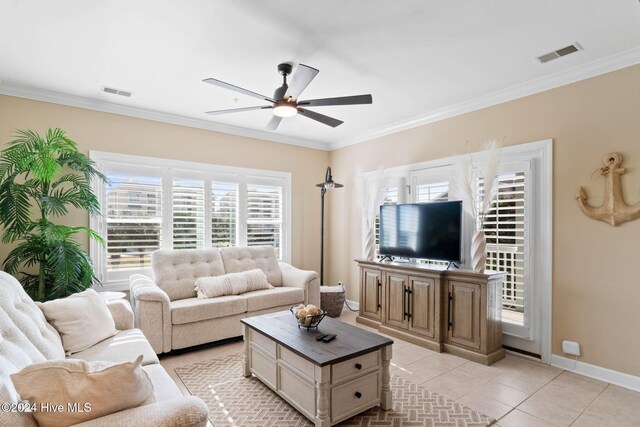 living room featuring ceiling fan, light tile patterned floors, and ornamental molding