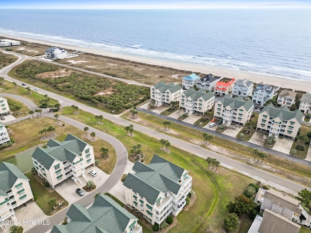 birds eye view of property with a water view and a view of the beach