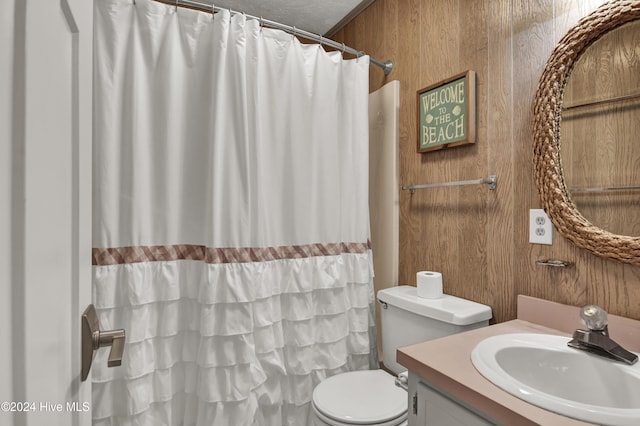 25 Newport St, Ocean Isle Beach, NC 28469 - bathroom with vanity, toilet, wood walls, and a shower with curtain