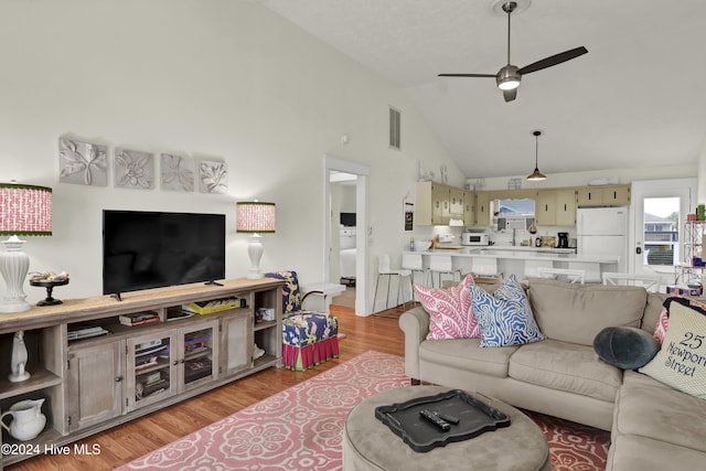 25 Newport St, Ocean Isle Beach, NC 28469 - living area featuring high vaulted ceiling, light wood-style flooring, and a ceiling fan