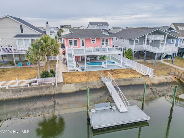 25 Newport St, Ocean Isle Beach, NC 28469 - dock with a deck with water view, a fenced backyard, stairway, and a residential view