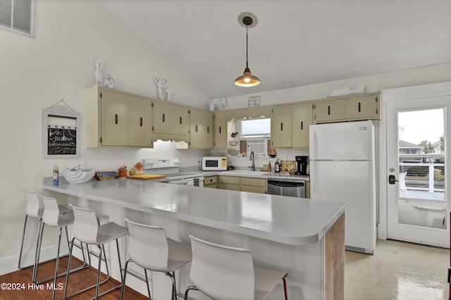 25 Newport St, Ocean Isle Beach, NC 28469 - kitchen with white appliances, cream cabinetry, light countertops, lofted ceiling, and a peninsula