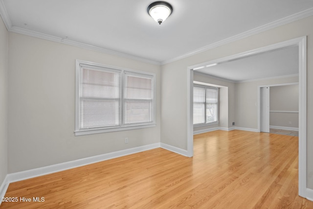 empty room with light hardwood / wood-style floors and crown molding