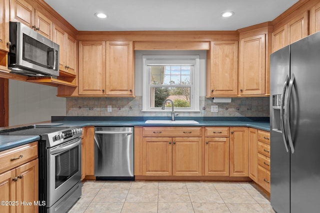 kitchen featuring appliances with stainless steel finishes, backsplash, light tile patterned floors, and sink