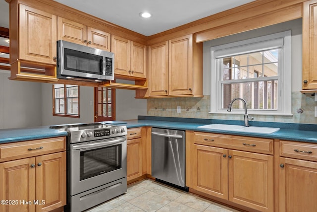 kitchen with light tile patterned floors, stainless steel appliances, tasteful backsplash, and sink