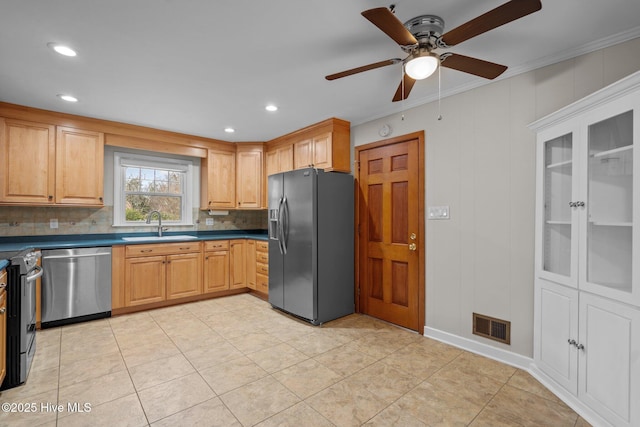 kitchen with stainless steel appliances, ceiling fan, crown molding, and sink