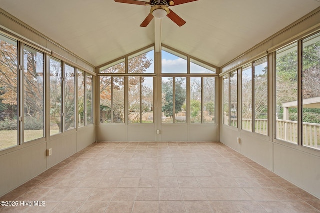 unfurnished sunroom with a wealth of natural light, vaulted ceiling, and ceiling fan