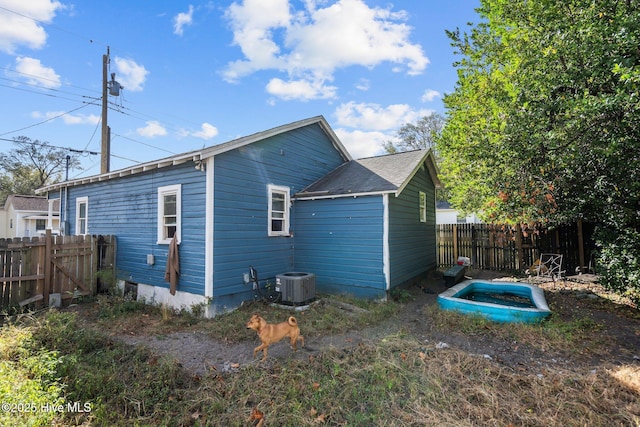 rear view of house featuring central air condition unit