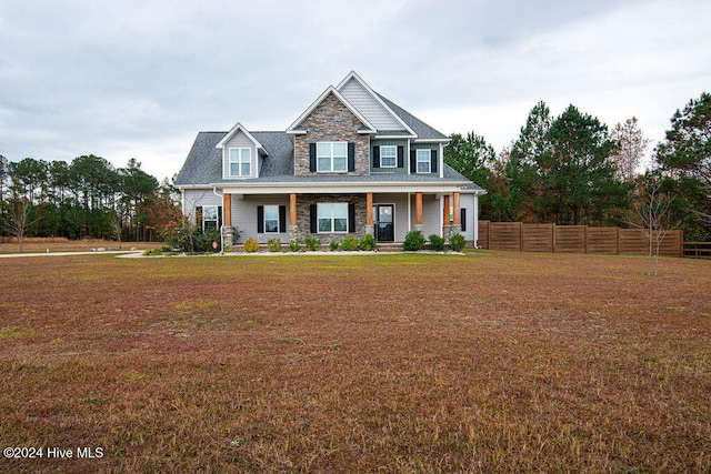 view of front of house with a porch and a front yard