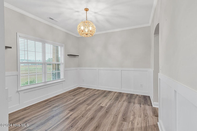 unfurnished room with hardwood / wood-style flooring, a wealth of natural light, and crown molding